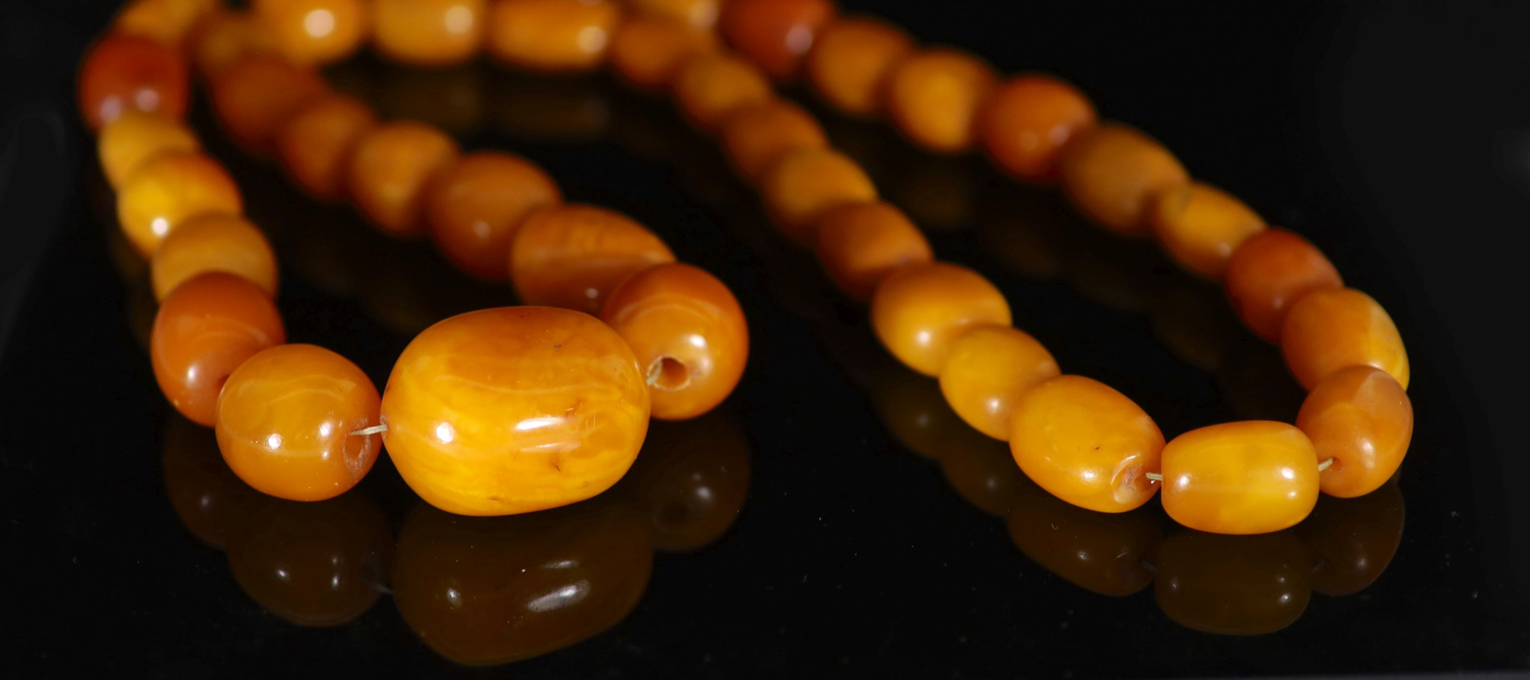 A single strand graduated oval amber bead necklace, 84cm, gross weight 182 grams,